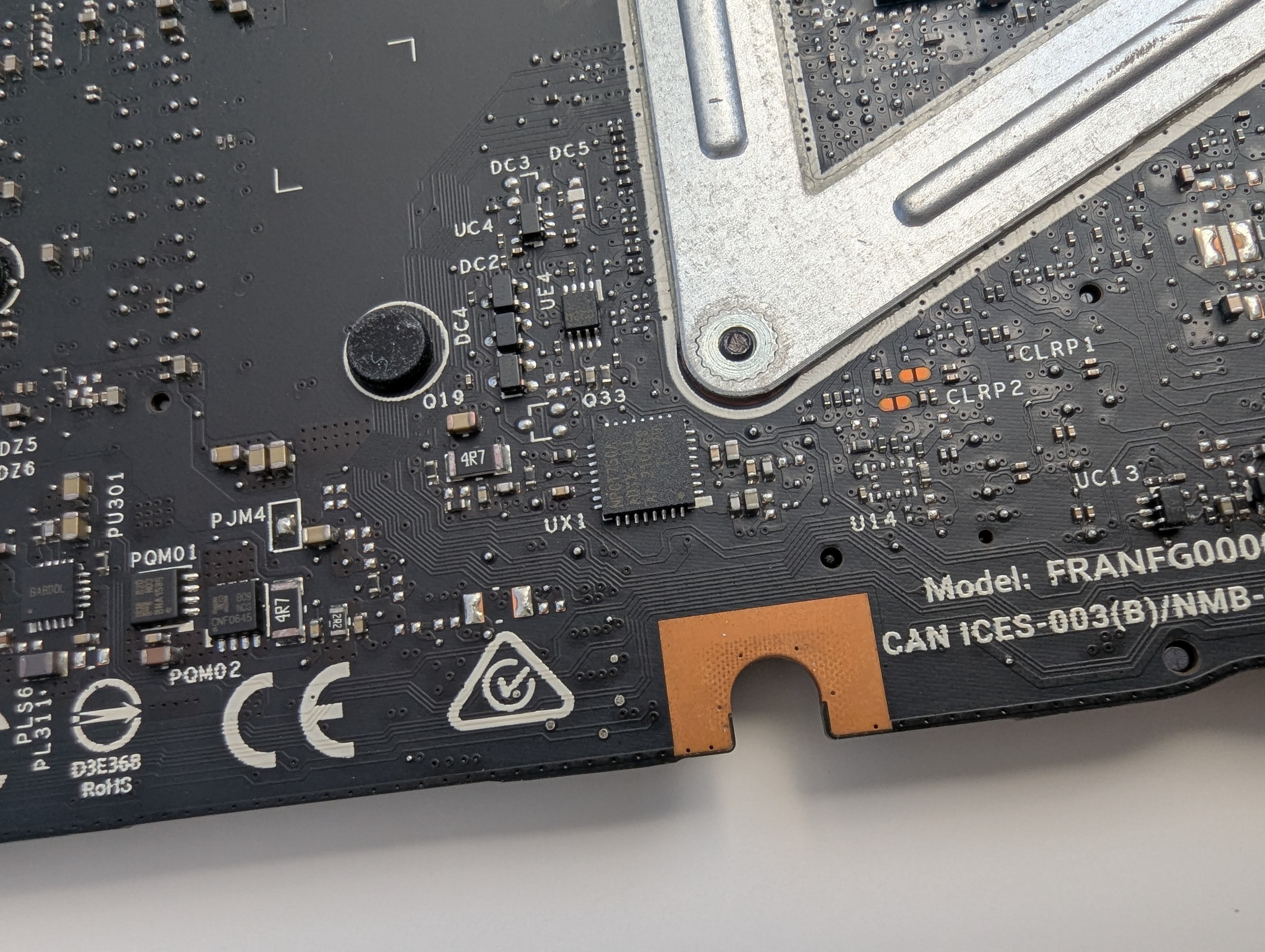 A zoomed in image of a framework 13 11th gen motherboard, showing the Nuvoton TPM chip